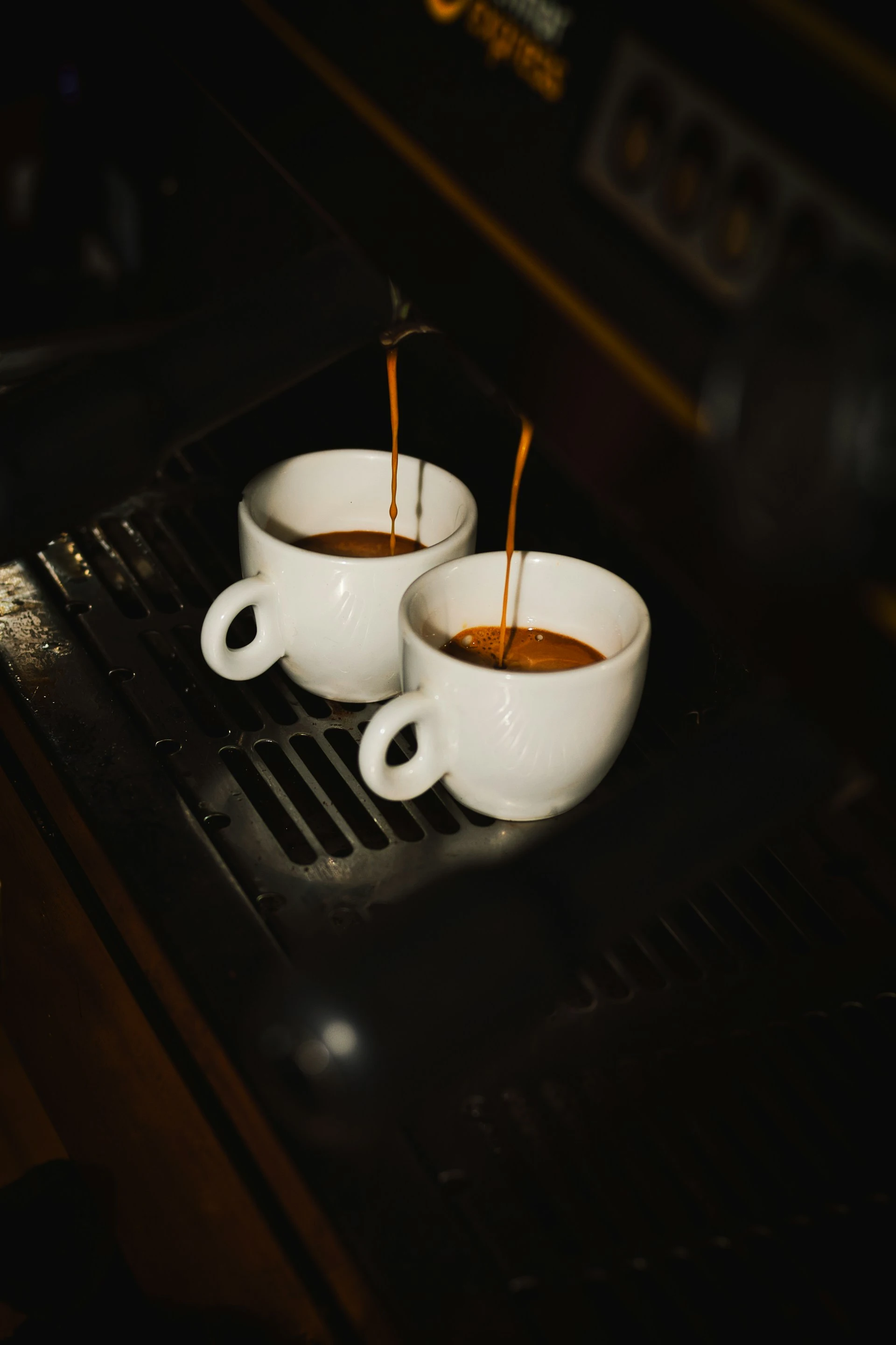 Two doppios being prepared side by side